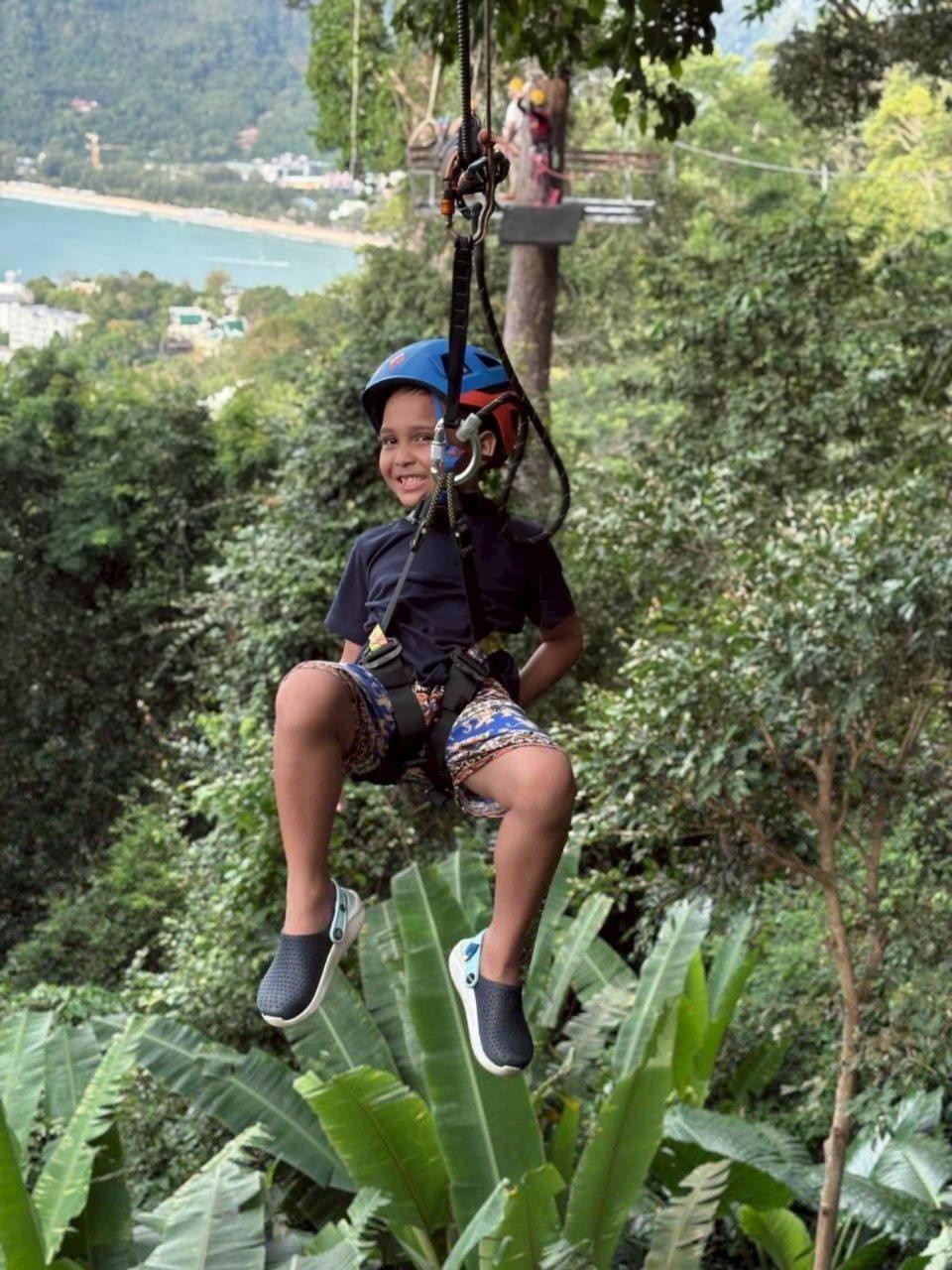 Smiling young rider on the zipline