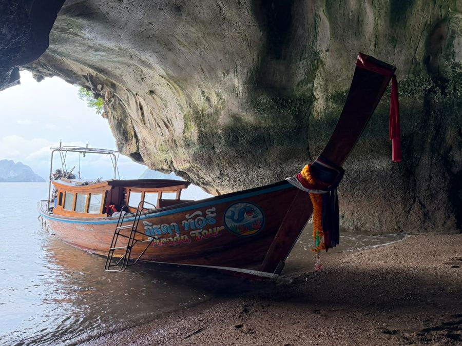 Long-tail boat in a sea cave