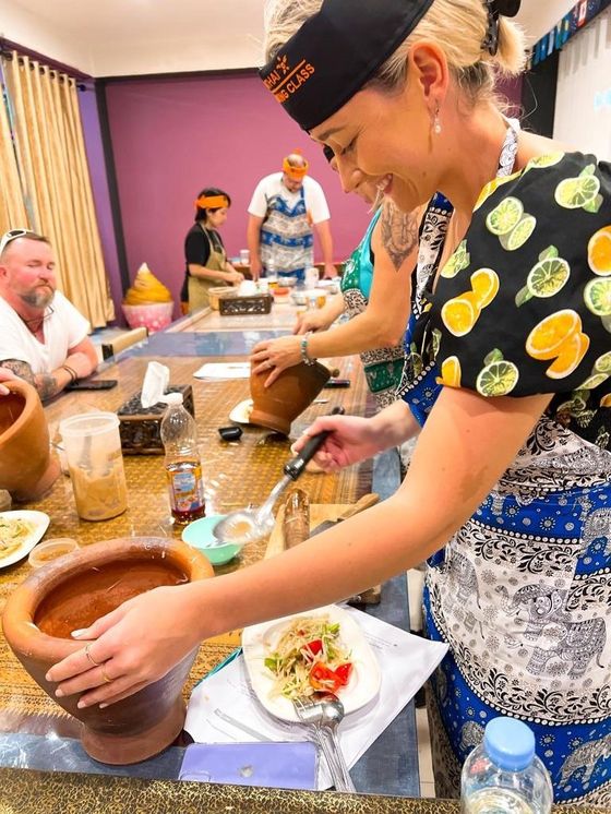 Cooking a Thai salad in a clay pot