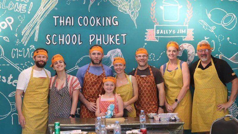 Guests in aprons at Kata Thai Cooking